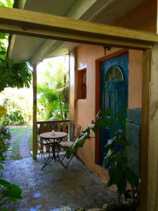 a patio with a table and a blue door at Miami Bungalow Oasis near Everglades & The Keys in Cutler Bay