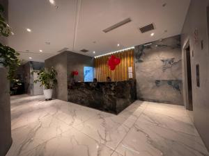 a lobby with marble walls and a marble floor at MIRAFLORES CITY HOTEL in Lima