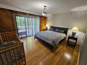 a bedroom with a bed and a large window at Cozy Chalet in Sainte-Adèle