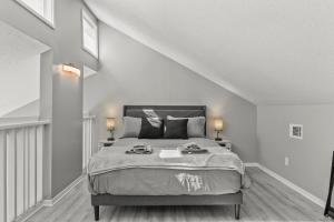 a bedroom with a large bed with two lamps at NEW King with Loft Beach Near Gulf in Gulfport