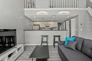 a living room with a couch and a kitchen at NEW King with Loft Beach Near Gulf in Gulfport