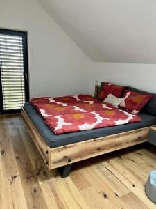 a bed sitting in a room with a wooden floor at Dolní Morava- Apartmán v Prostření Lipce in Králíky