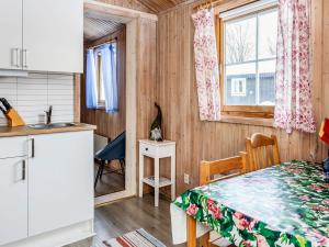 a kitchen and a dining room with a table in a room at Holiday home JÄRPEN II in Järpen