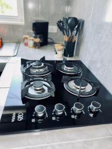 a stove top with four burners on a kitchen counter at Casa Tsunuum in Holbox Island