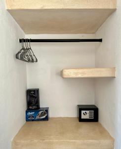 a room with a staircase with a shelf and a box at Casa Tsunuum in Holbox Island