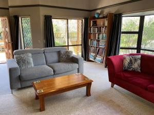 a living room with a couch and a coffee table at Chris's Cabin in Greytown