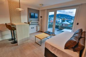 a bedroom with a bed and a balcony with a view at Patagonia Deluxe View in San Carlos de Bariloche