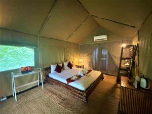 a bedroom with a bed in a tent at Khaosok Boutique Hideaway - Cliff Tent in Khao Sok National Park