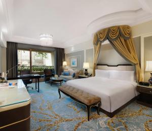 a bedroom with a bed and a living room at InterContinental Chengdu Global Center, an IHG Hotel in Chengdu