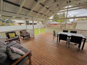 a patio with a table and chairs on a deck at Dempster House in Esperance