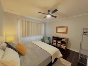 a bedroom with a bed and a ceiling fan at Dempster House in Esperance