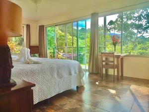 a bedroom with a bed and a large window at Hotel Finca 360 in Marsella