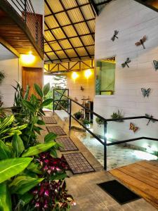 a house with a lobby with plants and butterflies on the wall at Hotel Finca 360 in Marsella