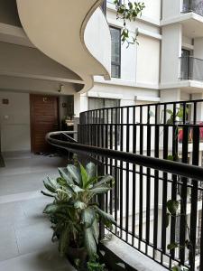 a hallway of a building with a black railing at GreyRooms in Dhaka