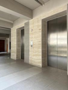 an empty lobby with elevators in a building at GreyRooms in Dhaka