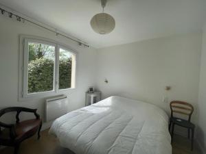 - une chambre blanche avec un lit et une fenêtre dans l'établissement Villa Capbreton, 4 pièces, 8 personnes - FR-1-413-226, à Capbreton
