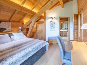 a bedroom with a bed and a desk and a chair at Chalet skis aux pieds avec spa et sauna, Alpe d'Huez - FR-1-645-41 in LʼHuez +9 photos