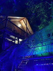 a building with a staircase with blue and green lights at Sukha Glamping in Rionegro