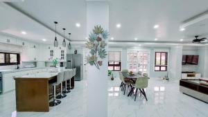 a kitchen and dining room with a table and chairs at Trail Bedz Homestay in Baguio