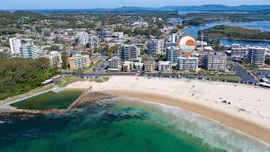 an aerial view of a beach in front of a city at Oceanic 19 - linen not included in Forster