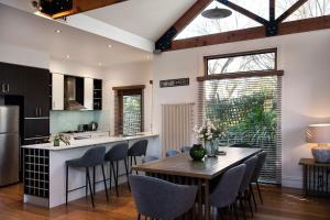 a kitchen and dining room with a table and chairs at Ravenswood in Daylesford