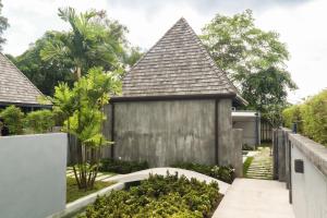 an external view of a house with a garden at Tao Resort and Villas (SHA Extra+) in Phuket Town