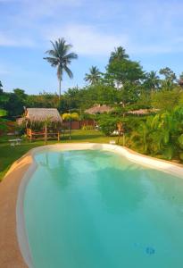 a large swimming pool in front of a resort at Samui Blue Bird in Mae Nam