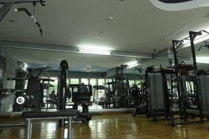 a gym with lots of equipment in a room at Apartemen Galeri Ciumbuluit 3 in Bandung