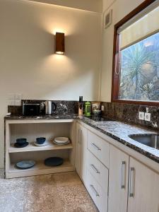 a kitchen with a sink and a counter at Seaside Villa Kecil in Sekotong