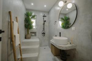 a bathroom with a sink and a mirror at MIRAMAR KARYSTOS in Karistos