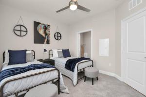 a bedroom with two beds and a ceiling fan at The Blue Horizon - Kemah Boardwalk - Galveston in Kemah