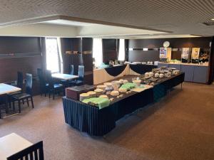 ein Esszimmer mit einem langen Tisch und Stühlen in der Unterkunft Oita Regal Hotel in Ōita