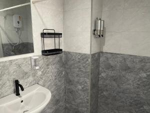 a bathroom with a sink and a mirror at Skipper's Karon in Karon Beach