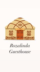 ein Gebäude mit den Worten roelandinia Greek house in der Unterkunft Rozalinda Guesthouse in Naryn