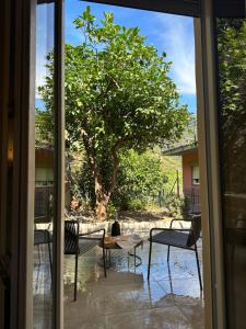 a sliding glass door with a view of a tree at The Upper House in Riomaggiore