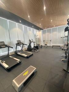 a gym with several treadmills and exercise bikes at Parc21 Luxury Boutique Hotel in Phnom Penh