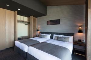 Postel nebo postele na pokoji v ubytování HOTEL CANATA KYOTO