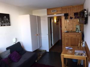a small living room with a couch and a table at Nice Flat Le Varet Arcs 2000 in Arc 2000