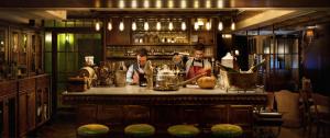 two men standing behind a bar in a kitchen at Hotel B Berdichevsky in Tel Aviv