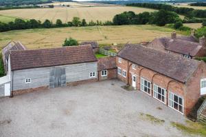 an aerial view of a barn with a large driveway at Stockbatch Granary in Shrewsbury