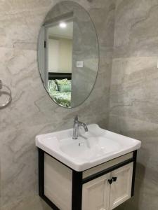 a bathroom with a sink and a mirror at Minutes away from Mangel Halto Beach in Savaneta