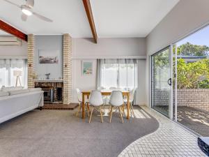 a living room with a table and chairs and a couch at 25 Oleander Avenue Shelly Beach QLD in Caloundra