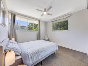 a bedroom with a bed and a ceiling fan at 25 Oleander Avenue Shelly Beach QLD in Caloundra