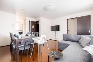 a living room with a table and a couch at FUJIMI TOWN HOUSE in Tokyo