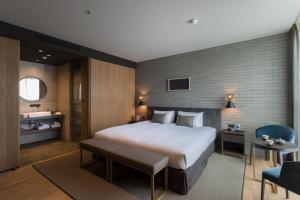 a bedroom with a large white bed in a room at HOTEL CANATA KYOTO in Kyoto
