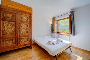 a small bedroom with a bed and a window at Studio Clotes Ski In - Ski Out - Happy Rentals in Sauze dʼOulx