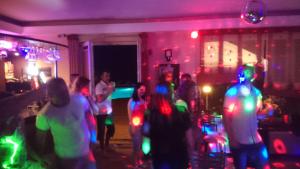 a group of people dancing in a room with lights at Brydar with Sauna, Swimming Pool and Jacuzzi in Mielno +77 photos