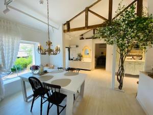 a kitchen and dining room with a white table and chairs at Gonae Reborn in Jeju