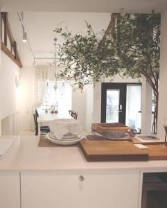 a kitchen with a table with plates and a tree at Gonae Reborn in Jeju