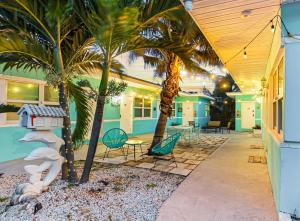 a house with palm trees and a patio at Downtown Hollywood Holiday Retreat Dania Beach in Hollywood